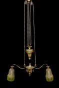 An early 20th century English ormolu counter balanced ceiling light with twin branches, swagged turn