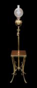 An Edwardian brass and copper telescopic oil lamp standard with scrolling underframe and etched