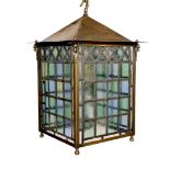 A large Edwardian lacquered brass and leaded glass hall lantern applied with rams head motifs,