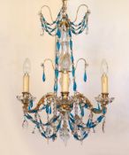 An early 20th century French gilt brass clear and blue glass four light chandelier, drop 80cm. width