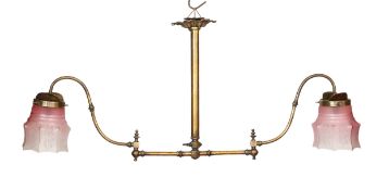 A late 19th century brass gasolier twin branch ceiling light with cranberry tinted etched glass