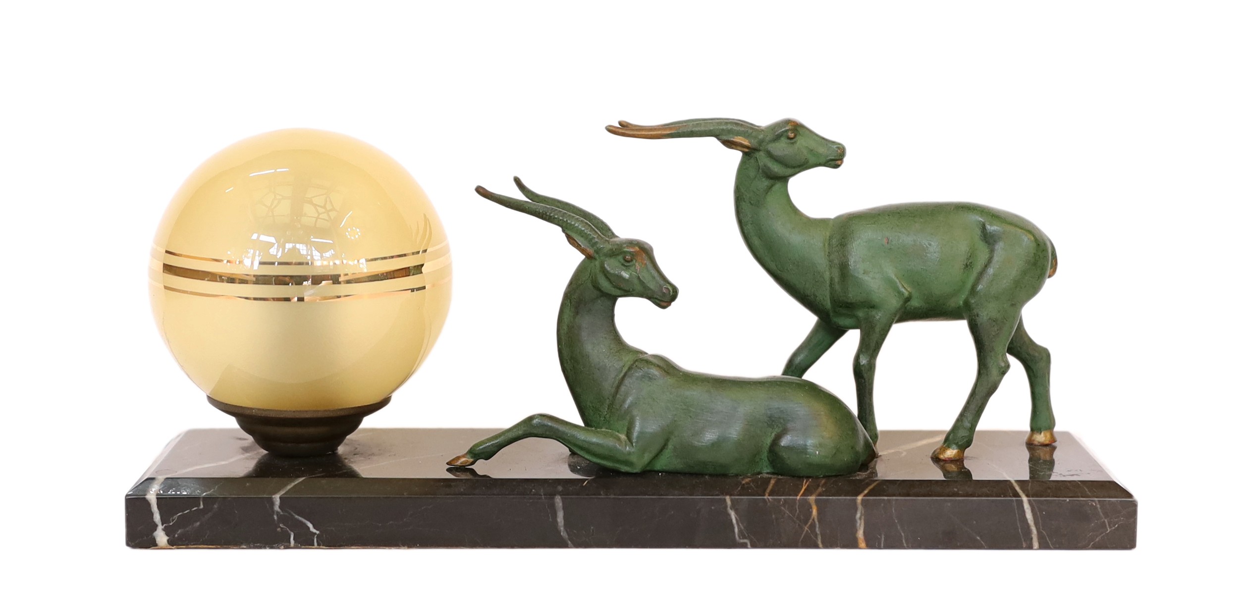 An Art Deco French bronze spelter and marble gazelles table lamp with etched spherical shade, height
