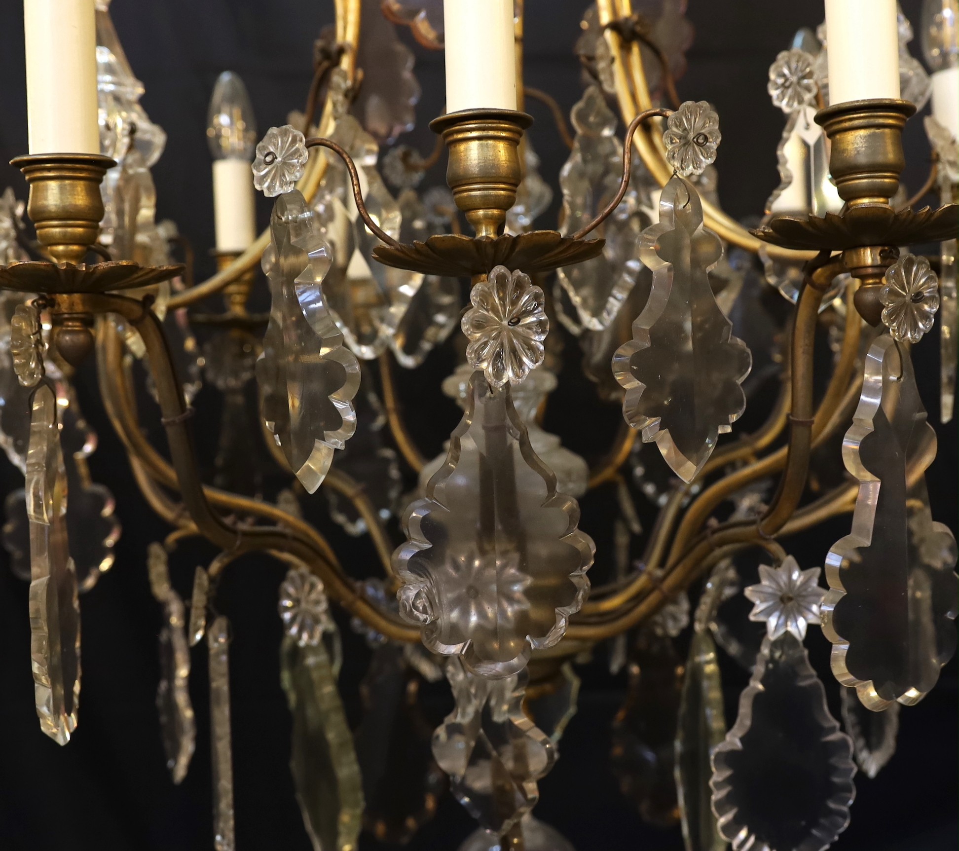 An early 20th century French gilt bronze and cut glass eight light chandelier profusely hung with - Image 2 of 4