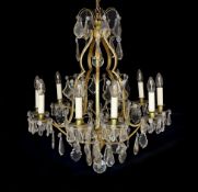 An early 20th century French silver and bronze and cut glass ten light chandelier hung with