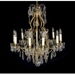 An early 20th century French silver and bronze and cut glass ten light chandelier hung with