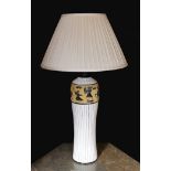 A 20th century Continental tinglazed pottery table lamp, decorated within a band of horse riders and
