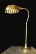 A 1930s English brass adjustable desk lamp, with flexible stem and scalloped shaped shade, height