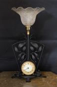 A 1930s English wrought iron table lamp inset with a Smiths Sectric timepiece, height overall