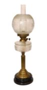 A late Victorian brass oil lamp with cut glass reservoir, duplex mechanism, etched glass globe and