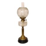 A late Victorian brass oil lamp with cut glass reservoir, duplex mechanism, etched glass globe and