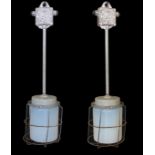 A pair of Czechoslovakian painted alloy industrial ceiling lights with caged Vaseline glass