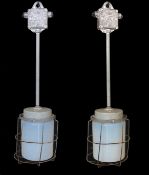 A pair of Czechoslovakian painted alloy industrial ceiling lights with caged Vaseline glass
