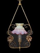 An English Arts & Crafts lacquered brass and copper gasolier with red tinted Vaseline glass shade,
