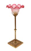 An early 20th century English lacquered brass table lamp with tinted and frosted glass shade, height