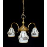 An early 20th century English lacquered brass light fitting with three stencilled opaque glass