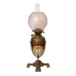 A Victorian brass mounted ceramic oil lamp in the manner of Dalton with brass reservoir and