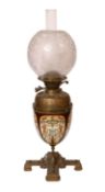 A Victorian brass mounted ceramic oil lamp in the manner of Dalton with brass reservoir and