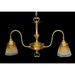 An early 20th century English brass twin branch light fitting with amber tinted tall glass shades