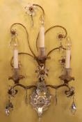 An early 20th century French gilt metal and Baccarat crystal triple branch wall light, height