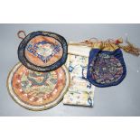 A Chinese embroidered sleeve band, two mats and a woven brocade bag.