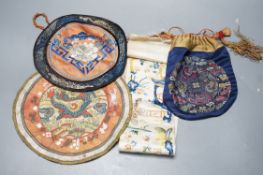 A Chinese embroidered sleeve band, two mats and a woven brocade bag.