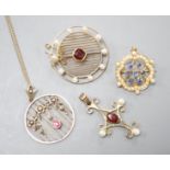 Three early 20th century yellow metal and gem set pendants or brooches, including sapphire and