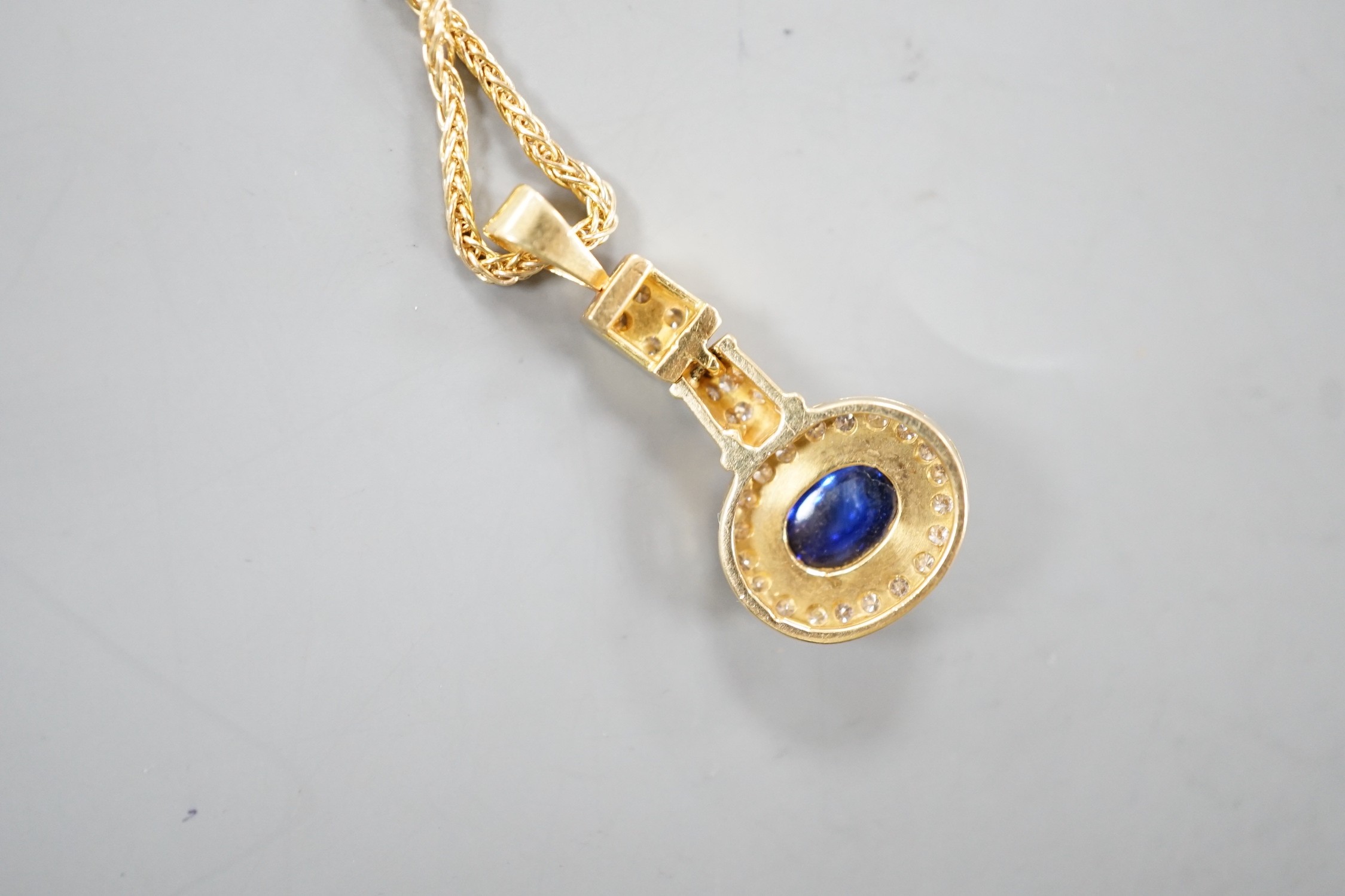 A modern yellow metal, cabochon sapphire and diamond set cluster pendant, overall 30mm, gross 4 - Image 2 of 2