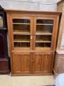 A Victorian glazed pitch pine four door school cabinet, width 146cm, depth 36cm, height 199cm