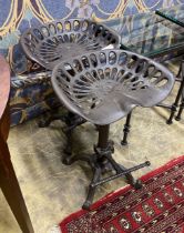 A pair of cast iron tractor seat stools, width 46cm, height 65cm