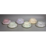 A set of six opalescent glass cups and saucers
