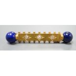 A yellow metal and three stone diamond set bar brooch. with lapis lazuli bead set terminals, 43mm,