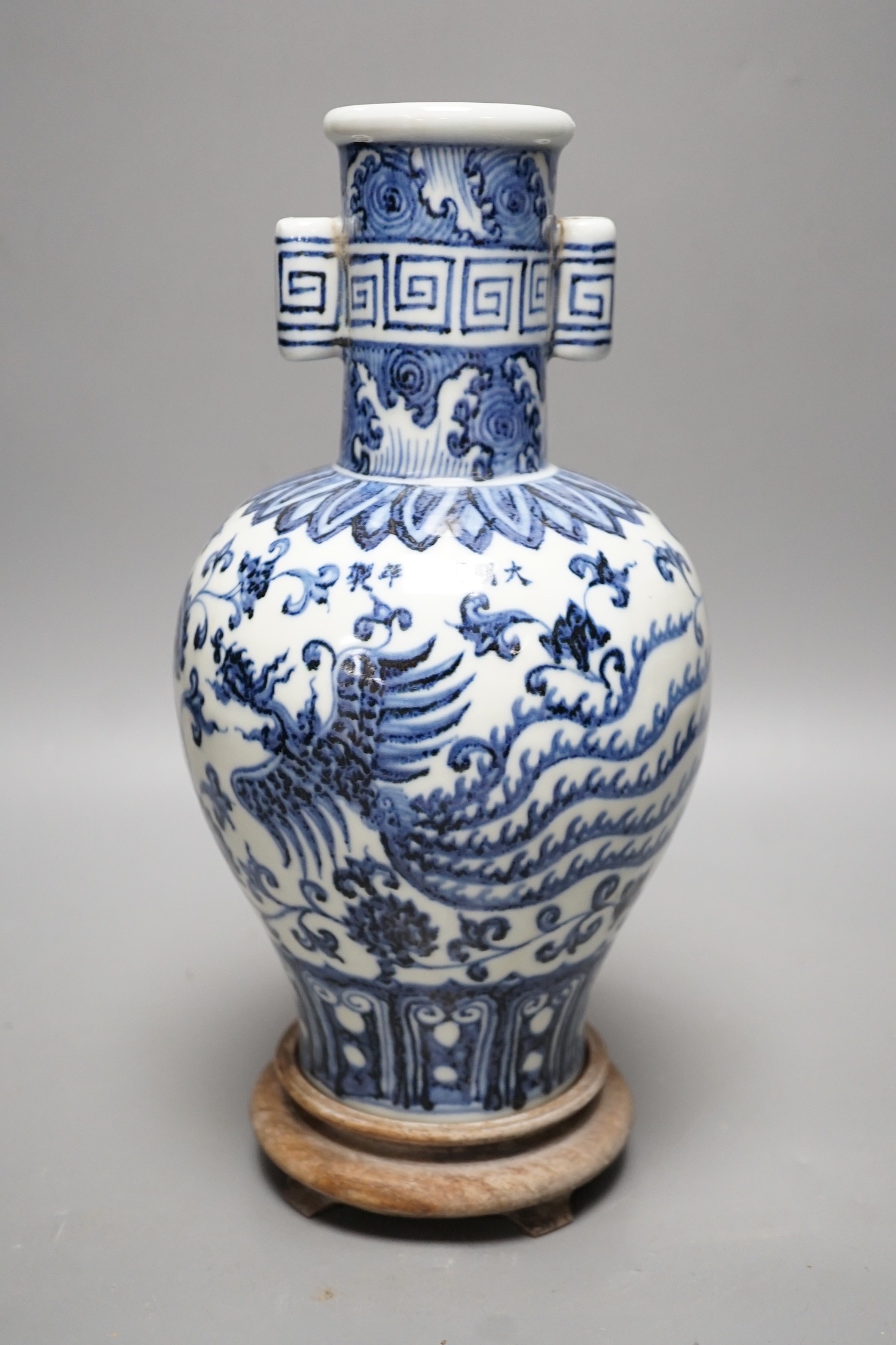 A Chinese blue and white vase on stand, 34cms high