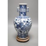 A Chinese blue and white vase on stand, 34cms high
