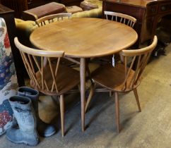 An Ercol elm and beech oval dining table, width 99cm, depth 89cm, height 71cm and four Chiltern