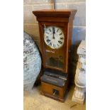 A late 19th / early 20th century National Time Recorder oak cased clocking in machine, height 109cm