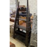 An Indian brass mounted carved hardwood three tier shelf unit, constructed from a 19th century ox