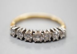 An 18ct gold and seven stone diamond set half hoop ring, size K, gross weight 1.8 grams.