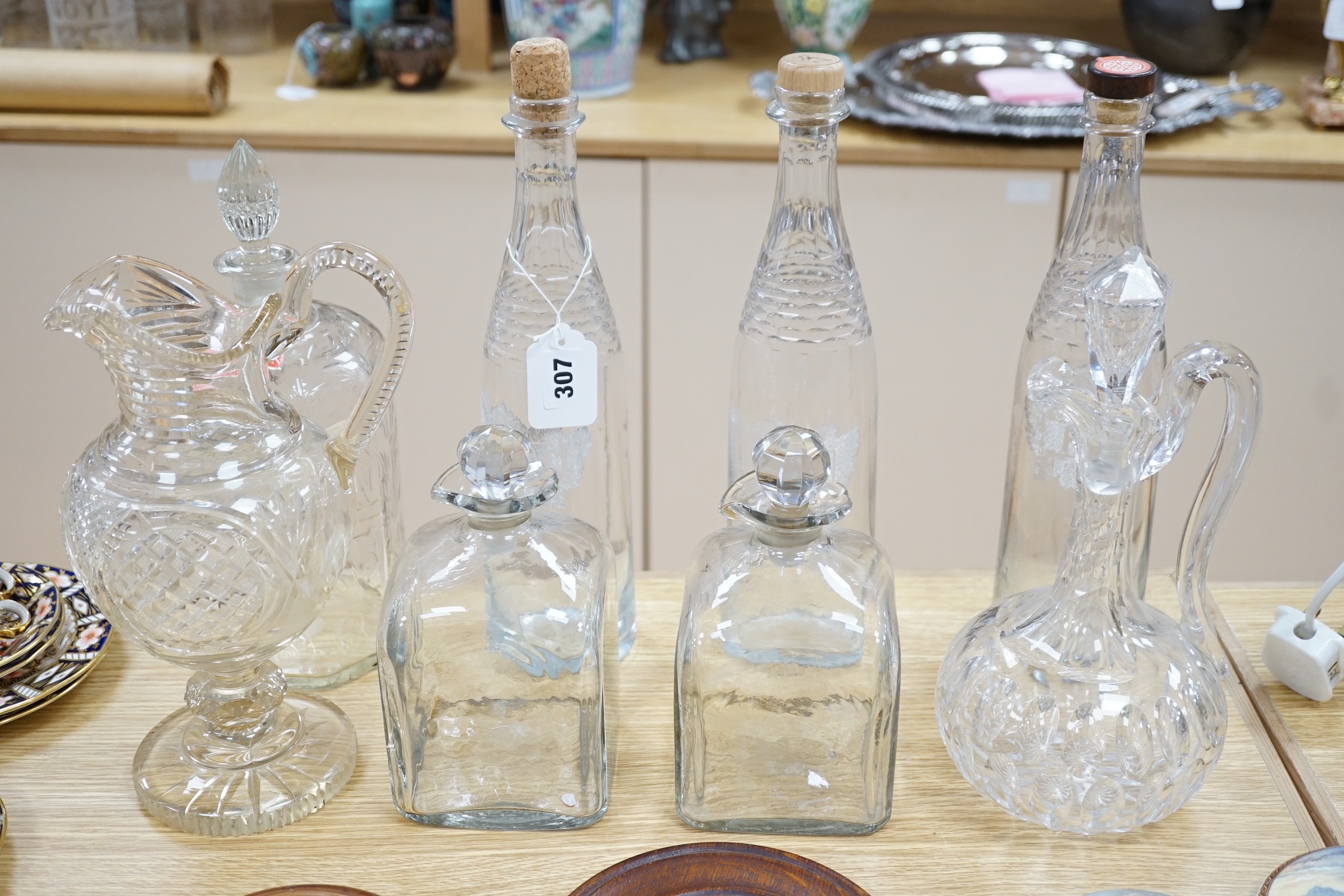 A Victorian cut glass Claret jug and stopper, a step cut pedestal jug, a pair of Dutch decanters,