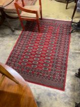 A Bokhara red ground rug, 186 x 126cm
