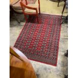 A Bokhara red ground rug, 186 x 126cm