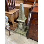 A carved natural stone obelisk finial, on a square plinth, height 102cm