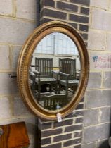 A Victorian style oval gilt framed wall mirror, width 67cm, height 84cm
