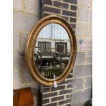 A Victorian style oval gilt framed wall mirror, width 67cm, height 84cm