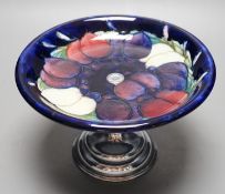 A Moorcroft wisteria pattern cake stand with chrome pedestal, 21cm diameter
