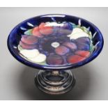 A Moorcroft wisteria pattern cake stand with chrome pedestal, 21cm diameter