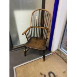 A mid 19th century ash, elm and beech Windsor comb back armchair, cut down, width 50cm, depth