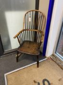 A mid 19th century ash, elm and beech Windsor comb back armchair, cut down, width 50cm, depth