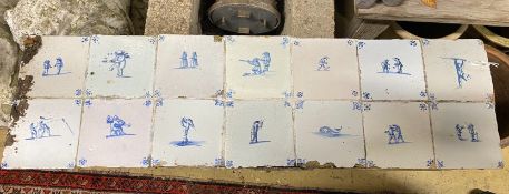 A set of ten mounted 18th century Dutch delft blue and white tiles, width 91cms, height 26cms.