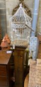 A stained pine pedestal with wirework bird cage, total height 174cm