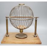 A mahogany and brass gaming tombola cage